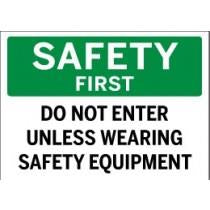 Safety sign with text 'SAFETY FIRST DO NOT ENTER UNLESS WEARING SAFETY EQUIPMENT' on a green and white background