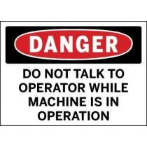 Safety sign warning 'Do not talk to operator while machine is in operation' with a red border.