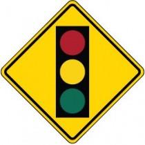 Warning sign indicating a traffic light ahead on a yellow background
