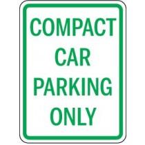 Compact car parking only sign with green text on a white background
