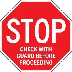 Red stop sign with text 'Check with guard before proceeding' on a white background