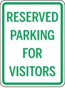 Reserved parking for visitors sign with green text on a white background
