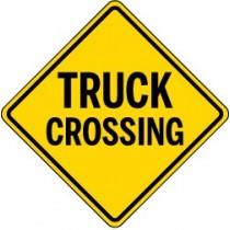 Yellow diamond-shaped traffic sign with 'TRUCK CROSSING' text on a white background