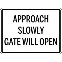 Warning sign with text 'Approach Slowly Gate Will Open' on a white background