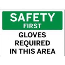 Safety sign with text 'SAFETY FIRST GLOVES REQUIRED IN THIS AREA' on a green and white background