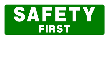 Green sign with 'SAFETY FIRST' text on a white background