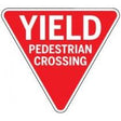 Yield Pedestrian Crossing sign with red background and white text