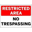 Sign with 'RESTRICTED AREA NO TRESPASSING' text on a white background