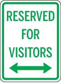 Sign indicating 'Reserved for Visitors' with arrows pointing left and right on a white background.