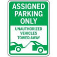 Green and white parking sign with text and a graphic of a tow truck.