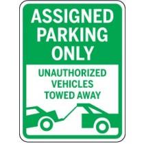 Green and white parking sign with text and a graphic of a tow truck.