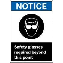 Safety sign with a symbol of a person wearing safety glasses and text 'Notice: Safety glasses required beyond this point'.