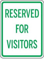 Sign with 'RESERVED FOR VISITORS' text on a white background