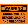 Warning sign with text 'WARNING: Chock wheels before loading and unloading' on an orange background.
