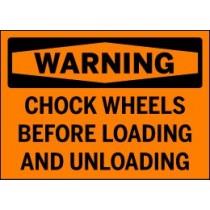 Warning sign with text 'WARNING: Chock wheels before loading and unloading' on an orange background.