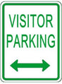 Visitor parking sign with green text and arrows on a white background