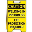 Caution sign warning of welding in progress and the need for eye protection.