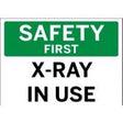 Safety sign indicating 'X-Ray In Use' with a green background and white text.