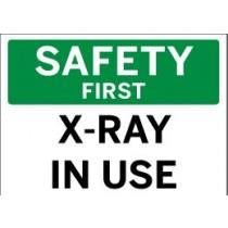 Safety sign indicating 'X-Ray In Use' with a green background and white text.