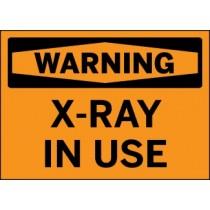 Warning sign with 'X-Ray In Use' text on an orange background