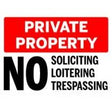 Private property sign with red border and black text on a white background