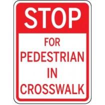 Traffic sign warning drivers to stop for pedestrians in crosswalks.