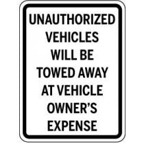 Sign warning about unauthorized vehicles being towed at owner's expense