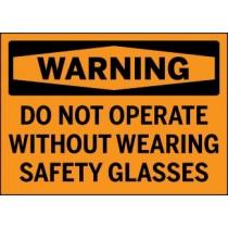Warning sign with text 'DO NOT OPERATE WITHOUT WEARING SAFETY GLASSES' on a black background