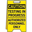 Yellow caution sign with black text 'Testing in progress, authorized personnel only' on a white background