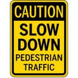 Caution sign warning of pedestrian traffic on a yellow background