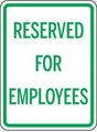 Sign with 'Reserved for Employees' text on a white background
