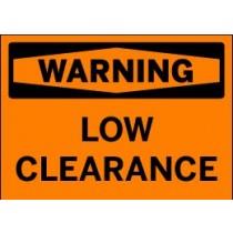 Orange warning sign with black text 'WARNING LOW CLEARANCE'