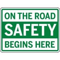 Safety sign on a green background with white text.