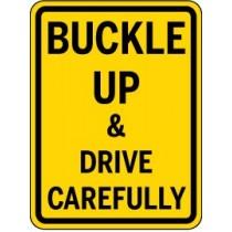 Yellow sign with black text 'Buckle Up & Drive Carefully'