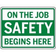 Safety sign with text 'On the Job Safety Begins Here' on a green background