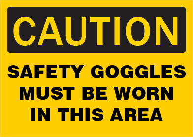 Caution OSHA sign with text 'Safety goggles must be worn in this area' on a yellow background