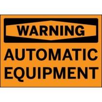 Warning sign for automatic equipment with black text on an orange background