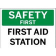 Safety first sign with 'First Aid Station' text on a green and white background