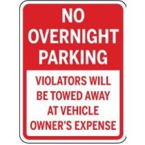 No overnight parking sign with text about towing fees.