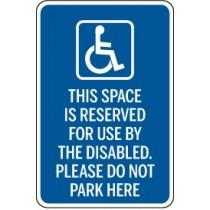 Blue sign with wheelchair icon and text reserved for disabled parking