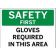 Safety sign with text 'SAFETY FIRST GLOVES REQUIRED IN THIS AREA' on a green and white background