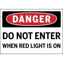 Danger sign warning 'Do not enter when red light is on' with a red circle and black border.