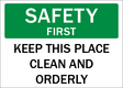 Safety sign with text 'SAFETY FIRST KEEP THIS PLACE CLEAN AND ORDERLY' on a green and white background